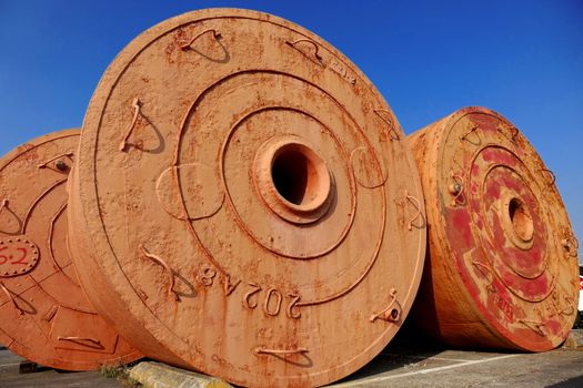 Large vintage mooring buoys are stored on dry land
