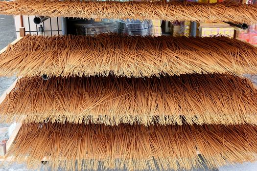 A store for religious artifacts dries incense sticks in the sun