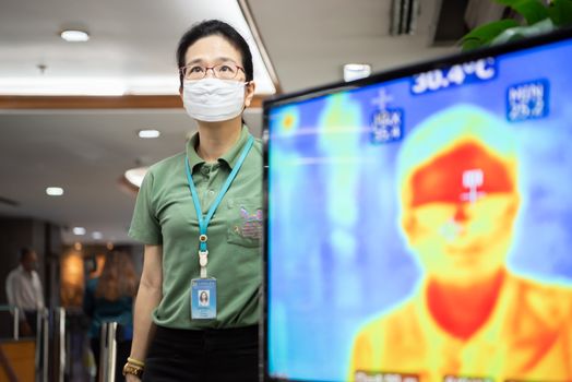 Bangkok, Thailand - March 18, 2020 : Unidentified people waiting body temperature check to access building for against epidemic flu covid19 or corona virus by thermoscan or infrared thermal camera