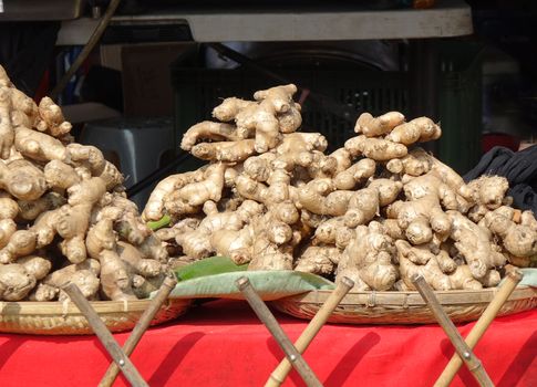 Fully grown ginger roots for sale at a market stall