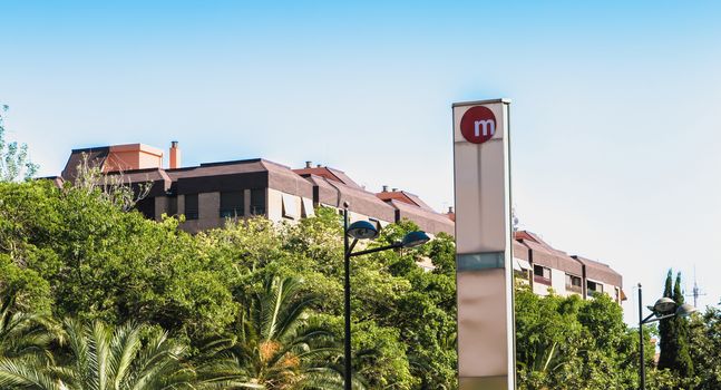 Valencia, Spain - June 18, 2017: sign indicating the entrance to a metro station in the city center on a summer day