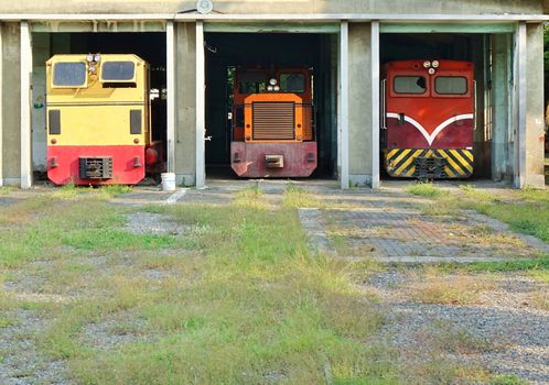 Vintage diesel powered train engines in an old shed
