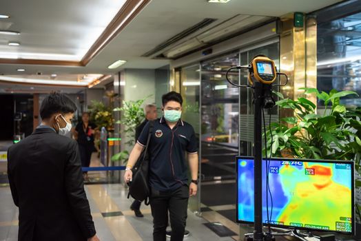 Bangkok, Thailand - March 17, 2020 : Unidentified people waiting body temperature check to access building for against epidemic flu covid19 or corona virus by thermoscan or infrared thermal camera