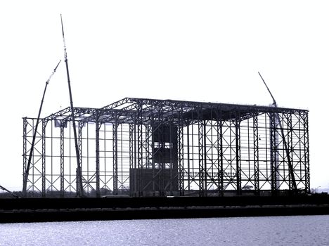 Monochrome image of a large steel structure construction
