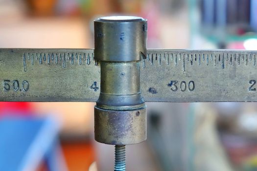 The beam and slider of a vintage commercial retail scale
