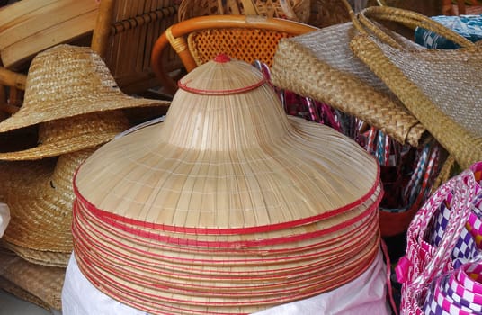 Handmade hats made from bamboo are on sale at an outdoor market