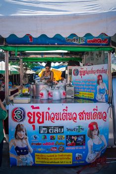 Samut Sakorn, Thailand - February 15, 2020 : Unidentified Asian sexy woman chef cooking a noodle soup with meat ball (kauy-tiew) for sale at Thai street food market or restaurant in Thailand