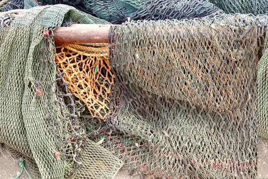 A bunch of old broken fishing nets are lying on the docks
