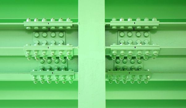 Massive steel girder construction with multiple large bolts and nuts

