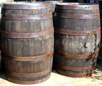 Vintage wooden oak barrels with rusting hoops