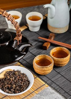 Hot tea in glass teapot and cup with steam