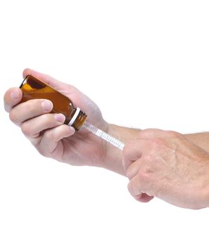 Hands with a Syrup bottle with syringe.