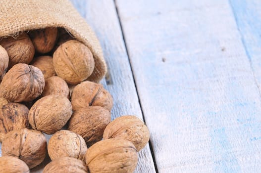 Walnuts on wooden table in the kitchen.