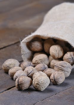 Walnuts on wooden table in the kitchen.