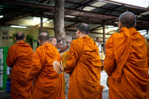 Bangkok, Thailand - January 1, 2020 : Unidentified thai monk ask for alms in morning for buddhist to make merit to offer food to the monks and receive blessing from the monks