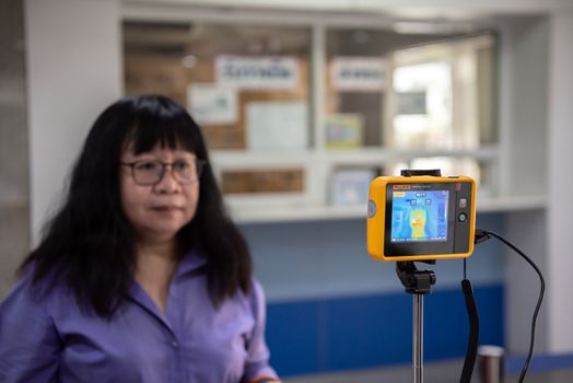 Bangkok, Thailand - March 18, 2020 : Unidentified people waiting body temperature check to access building for against epidemic flu covid19 or corona virus by thermoscan or infrared thermal camera