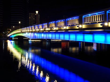 Evening view of the Love River with one of its illuminated bridges 