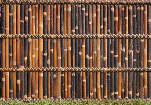 A traditional bamboo fence made from slats and strips
