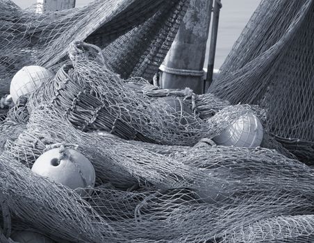 A pile of old fishing nets with hollow round plastic floats