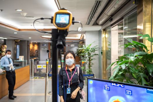 Bangkok, Thailand - March 18, 2020 : Unidentified people waiting body temperature check to access building for against epidemic flu covid19 or corona virus by thermoscan or infrared thermal camera