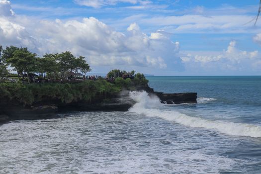 Batu Bolong beach which has an tourism attraction spot, close to Tanah Lot temple on the top of the hill. Small bay and sandy beach adjacent to Pura Batu Bolong in Bali, Indonesia. Natural background.