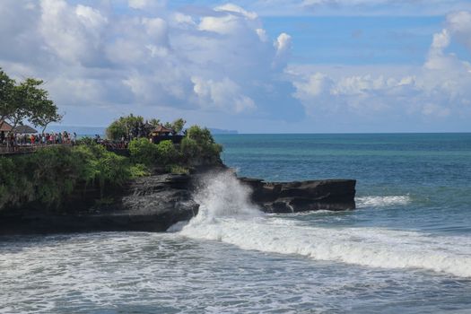Batu Bolong beach which has an tourism attraction spot, close to Tanah Lot temple on the top of the hill. Small bay and sandy beach adjacent to Pura Batu Bolong in Bali, Indonesia. Natural background.