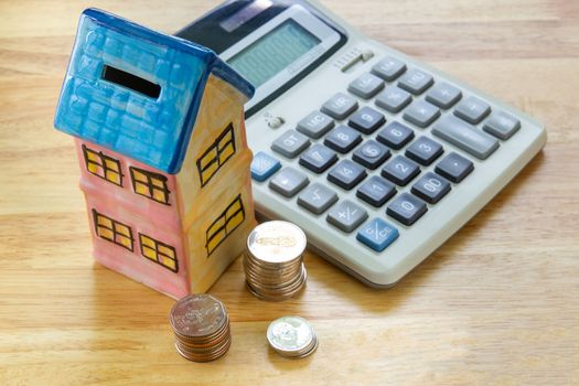Model house with calculator, concept 

Buying a house, residence, business, finance