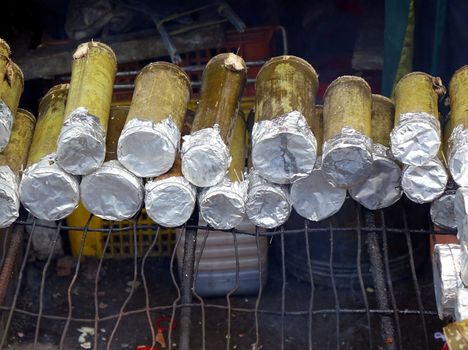 Fragrant rice with mushrooms is cooked in bamboo tubes
