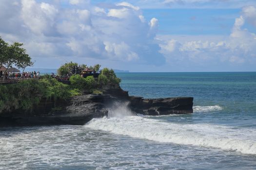Batu Bolong beach which has an tourism attraction spot, close to Tanah Lot temple on the top of the hill. Small bay and sandy beach adjacent to Pura Batu Bolong in Bali, Indonesia. Natural background.