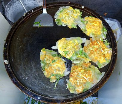 Oyster omelets with fresh greens are a popular Taiwan street food
