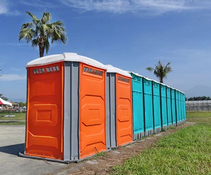 A row of portable toilets set up at a public event