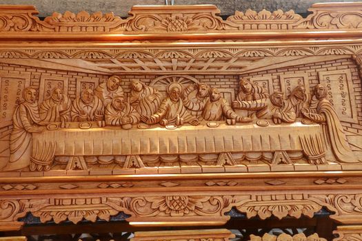 Scene of the last dinner carved in wood. Pattern of Supper carved on wood. Jesus shared with Apostles in Jerusalem before crucifixion wood carving. Wood carving decoration depicting stories from Bible
