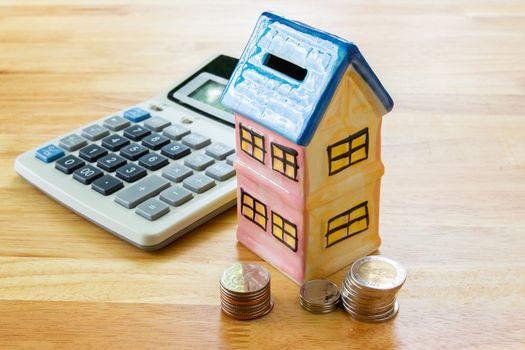 Model house with calculator, concept 

Buying a house, residence, business, finance