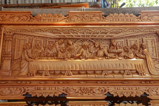 Scene of the last dinner carved in wood. Pattern of Supper carved on wood. Jesus shared with Apostles in Jerusalem before crucifixion wood carving. Wood carving decoration depicting stories from Bible
