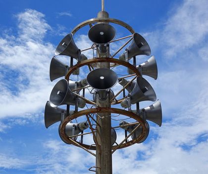 A large outdoor public address system with stacks of megaphones