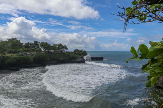 Batu Bolong beach which has an tourism attraction spot, close to Tanah Lot temple on the top of the hill. Small bay and sandy beach adjacent to Pura Batu Bolong in Bali, Indonesia. Natural background.