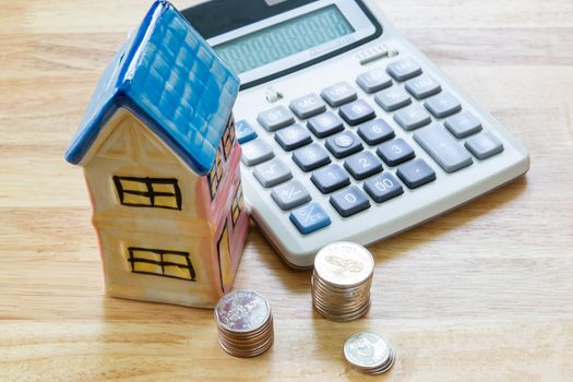 Model house with calculator, concept 

Buying a house, residence, business, finance
