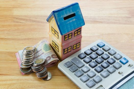 Model house with calculator, concept 

Buying a house, residence, business, finance