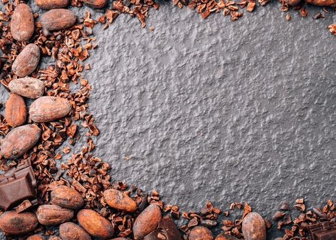 Dark chocolate pieces crushed and cocoa beans, top view