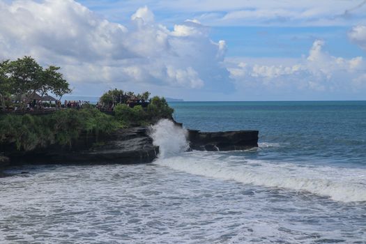 Batu Bolong beach which has an tourism attraction spot, close to Tanah Lot temple on the top of the hill. Small bay and sandy beach adjacent to Pura Batu Bolong in Bali, Indonesia. Natural background.
