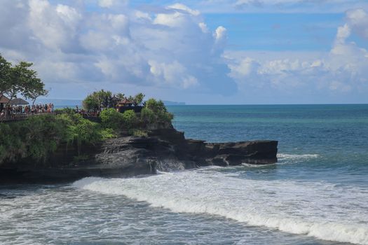 Batu Bolong beach which has an tourism attraction spot, close to Tanah Lot temple on the top of the hill. Small bay and sandy beach adjacent to Pura Batu Bolong in Bali, Indonesia. Natural background.