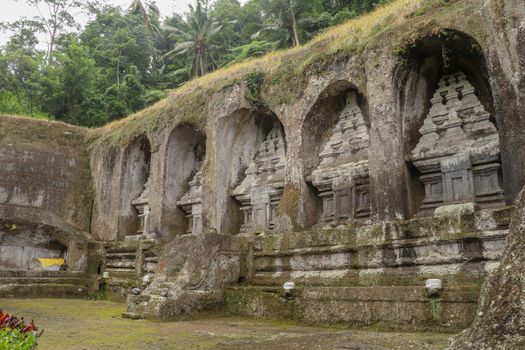 Ganung Kawi Temple complex centered around Royal Tombs carved into stone cliffs in the 11th century. Bali, Indonesia. Funeral temple complex centered around royal tombs carved into stone cliffs.