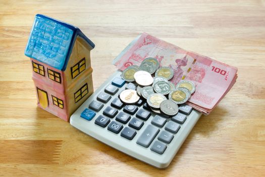 Model house with calculator, concept 

Buying a house, residence, business, finance