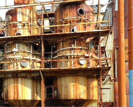 Large rusting storage tanks at a vintage industrial facility