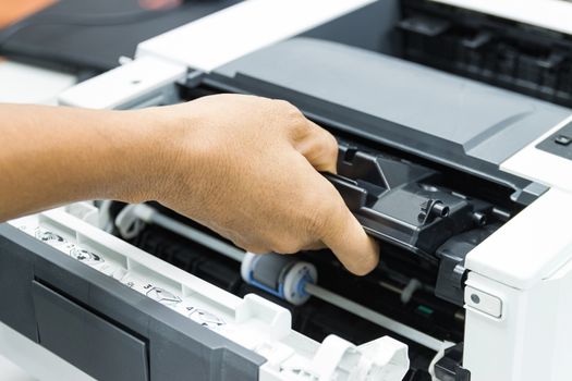 Technicians replacing toner in laser printer concept office supplies repair