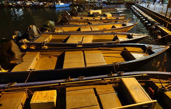 Small boats in a small fishing harbor at night