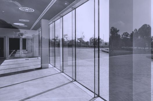 Architectural detail with glass, reflections, sunlight and shadows
