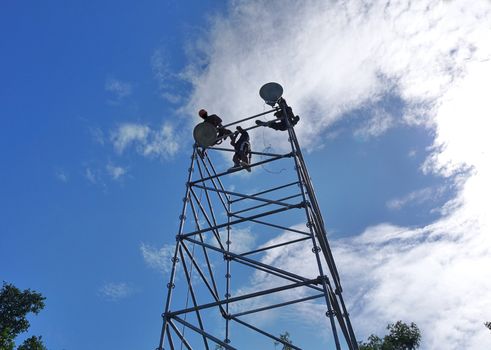 A scaffold and speakers are setup for an outdoor event