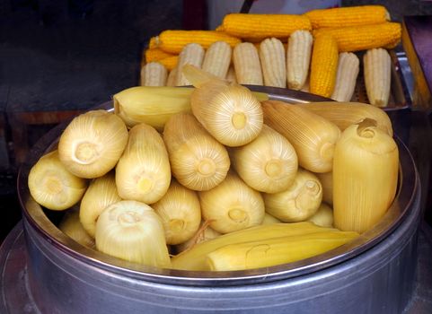 A market stall sells freshly steamed corn