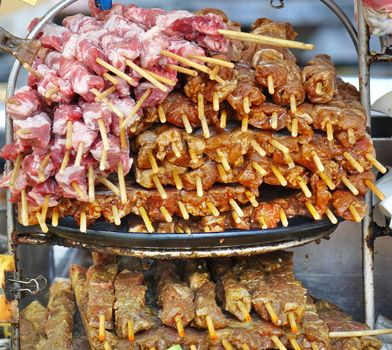 A street food stall in Taiwan offers a variety of meat skewers